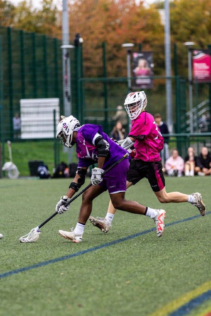 Keran playing lacrosse mid-match